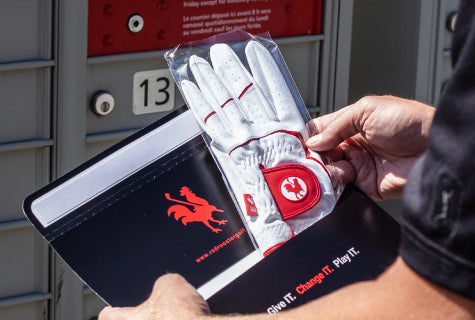Red Rooster Golf Glove being opened from the packaging